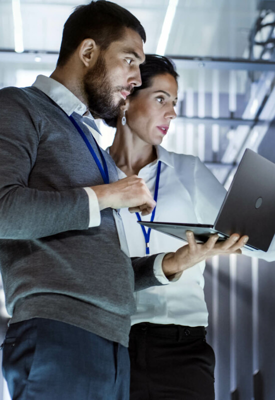 Two people working on a laptop